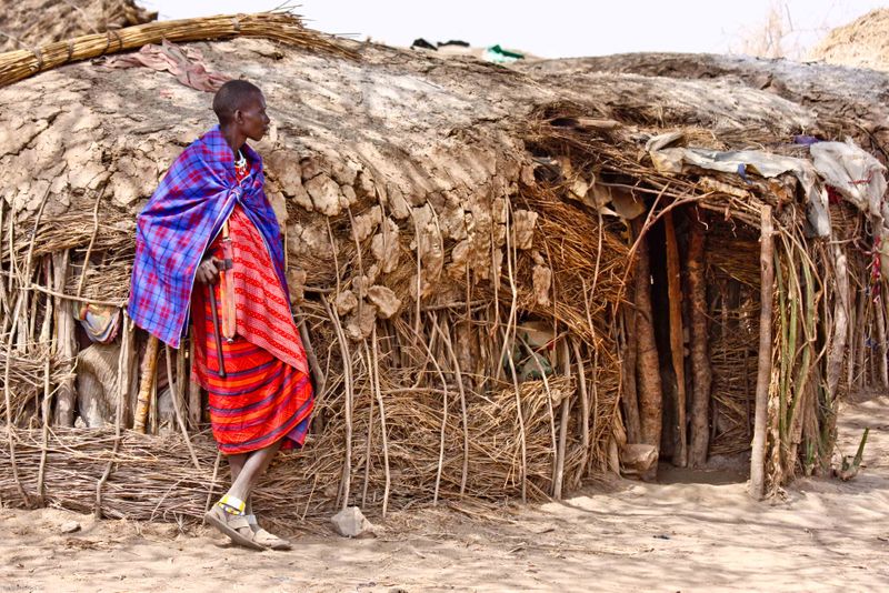 Masai man in front of the traditional nomadic hut